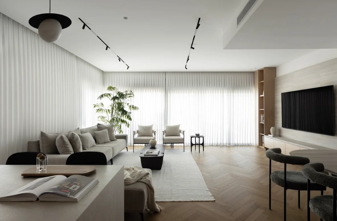 Modern minimalist living room with white walls and wooden flooring